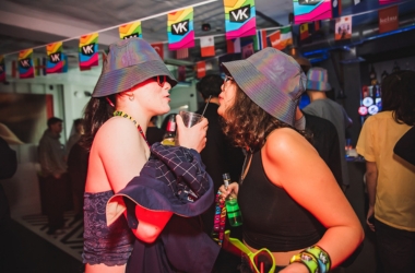 two women in bucket hats facing each other